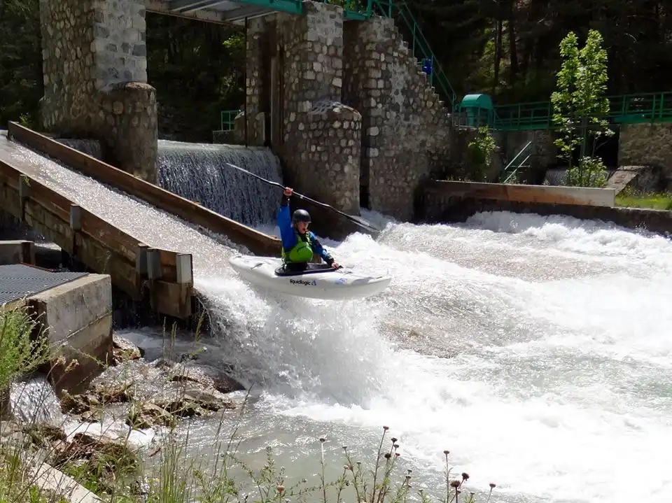 kayaker mid air on whitewater river